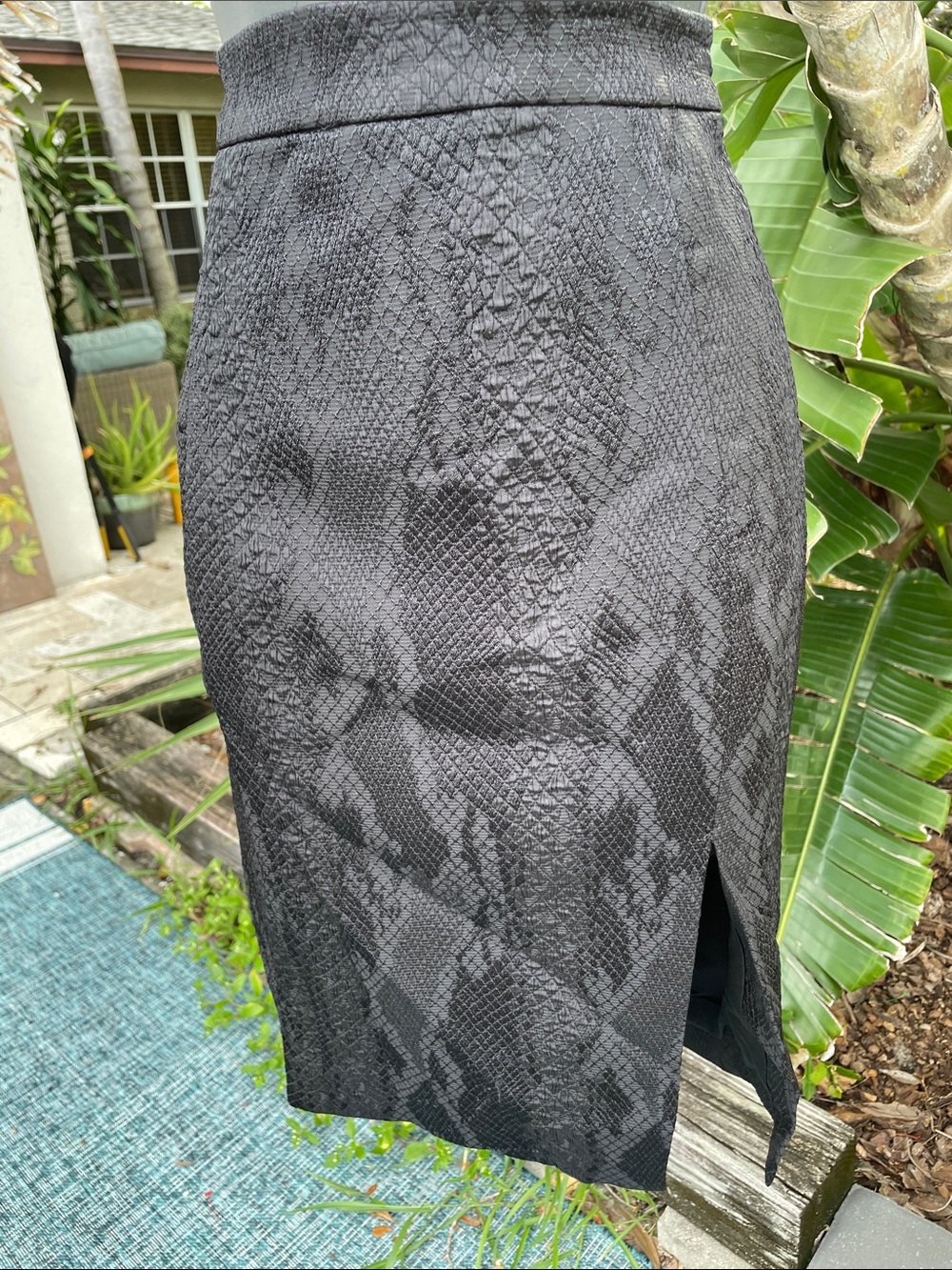 Black snake print pencil skirt with high back slit and exposed zipper